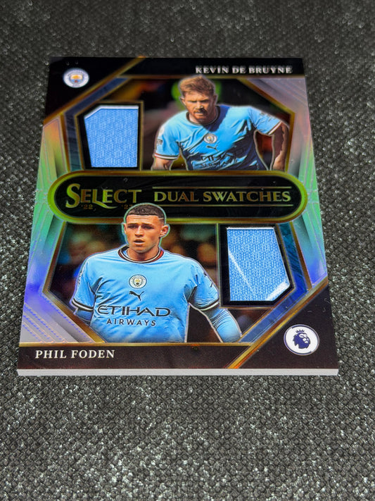 2022-23 Panini Select Premier League Soccer Dual Swatches Silver Prizm - Phil Foden & Kevin De Bruyne