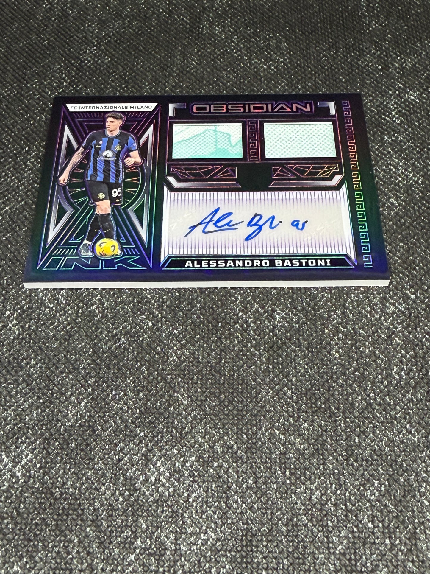 2023-24 Panini Obsidian Soccer Volcanic Dual Jersey Ink 28/50 - Alessandro Bastoni