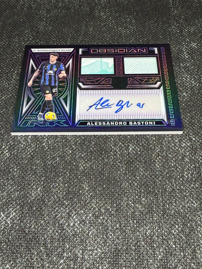 2023-24 Panini Obsidian Soccer Volcanic Dual Jersey Ink 28/50 - Alessandro Bastoni