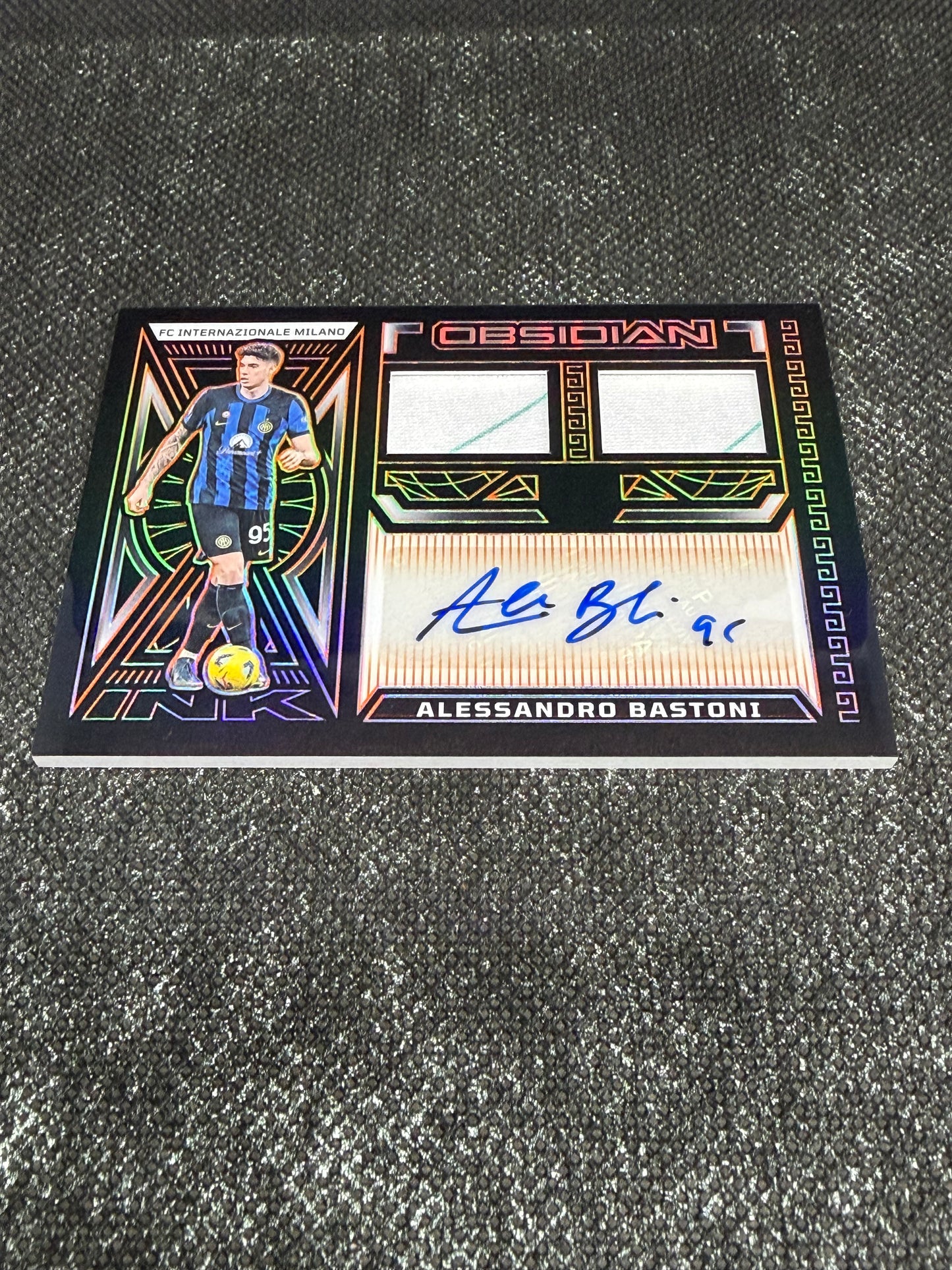 2023-24 Panini Obsidian Soccer Volcanic Dual Jersey Ink 04/99 - Alessandro Bastoni